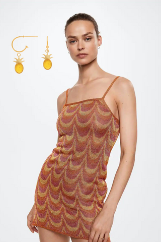 Small orange earrings combined with a short lurex dress