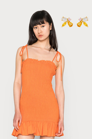 Short orange dress with orange stone earrings