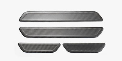 https://cdn.shopify.com/s/files/1/0266/2688/3639/products/pimpmyev-scuff-plates-4pcs-genuine-carbon-fiber-style-scuff-plates-door-sill-covers-for-model-y-matte-2020-2021-15216368746551_420x.jpg?v=1628238098