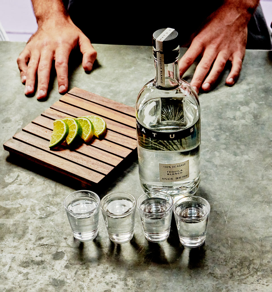 Hiatus tequila with shots in front of the bottle.