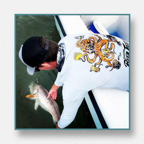 Man wearing Charleston Beer Fest Graphic Tee while fishing