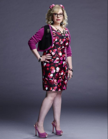 tv character Penelope Garcia wearing a dress and glasses