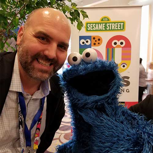 Our Founder, Michael Baird with Cookie Monster at the Licensing Show | Rubber Chicken Marketing