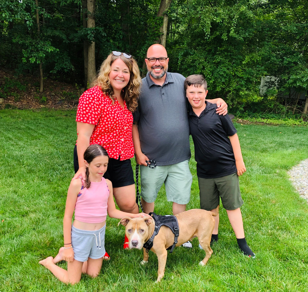 family with tripod dog