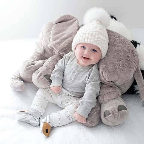 baby with elephant pillow