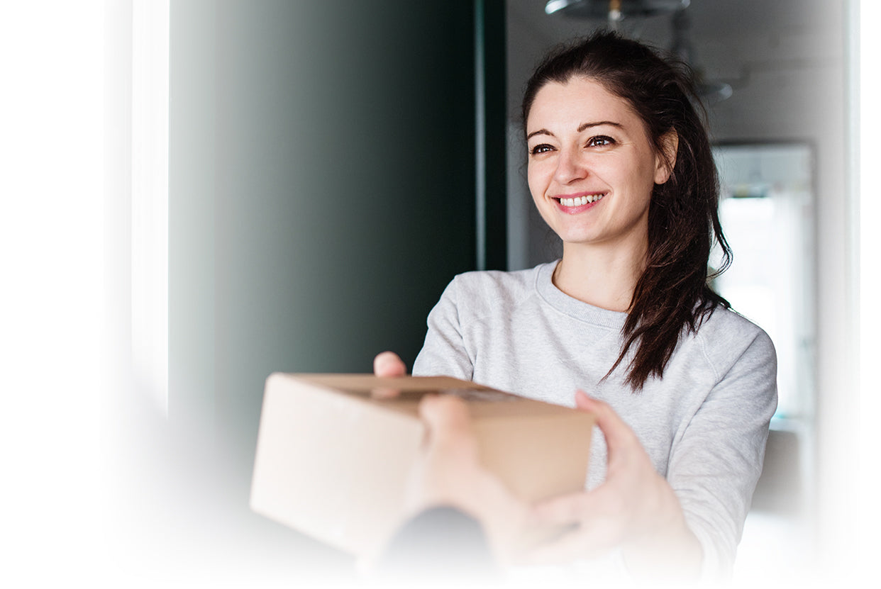 woman receiving package delivery at her door