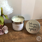 large candle in a silver tin with the words "take some time for you" on the lid