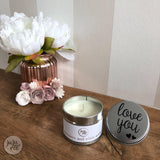 small candle in a silver tin with the words 'love you' on the lid