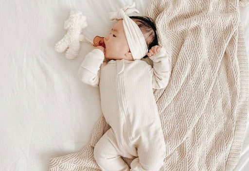 An image of a baby wearing sleepwear available on Luca Elle's online store