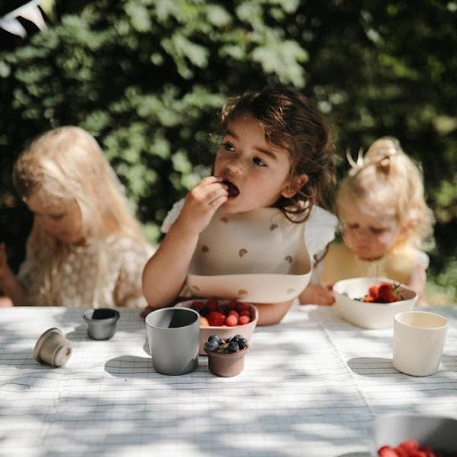 An image of a child using some of the best toddler cutlery when feeding himself