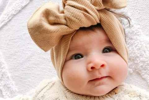 smiling baby in headband