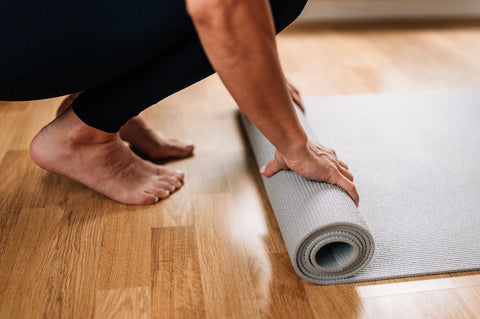 person laying the mat, carpet, after exercise