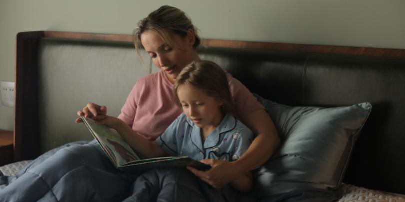 Mother and Daughter Sat On Bed Under Blue YNM Weighted Blanket