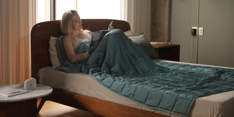 Woman Reading on Bed Reading Under Fresh Mint YNM Weighted Blanket