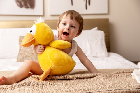 Child plays with weighted duck toy
