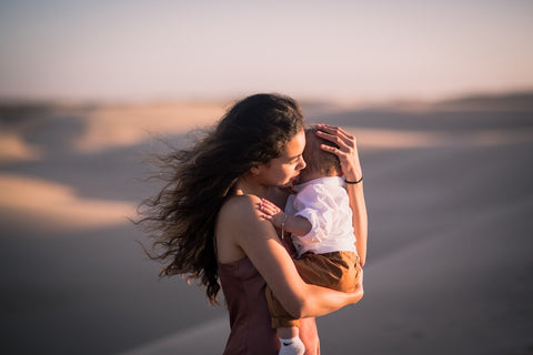 Women mother hugging baby kid