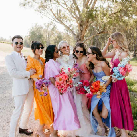 Bridesmaids laughing while posing for a wedding photo