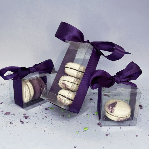 White macarons wrapped in purple bows at Oh La La! Macarons