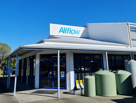 An exterior view of the front door and signage at the Allflow retail store. 