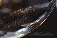 liquid inclusions to look "iridescent confetti" in aquamarine gemstone