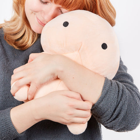 A woman hugging a big pillow penis
