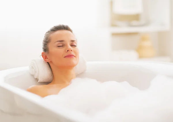 person soaking in bathtub