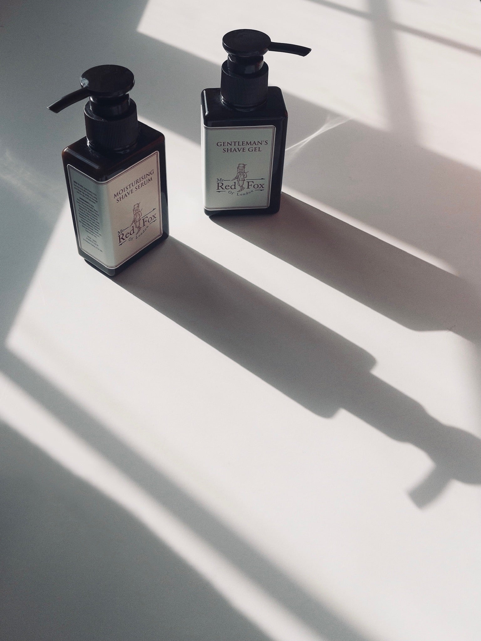 mr red fox of London moisturising shave serum sat in the sunlight creating wonderful shadows. 