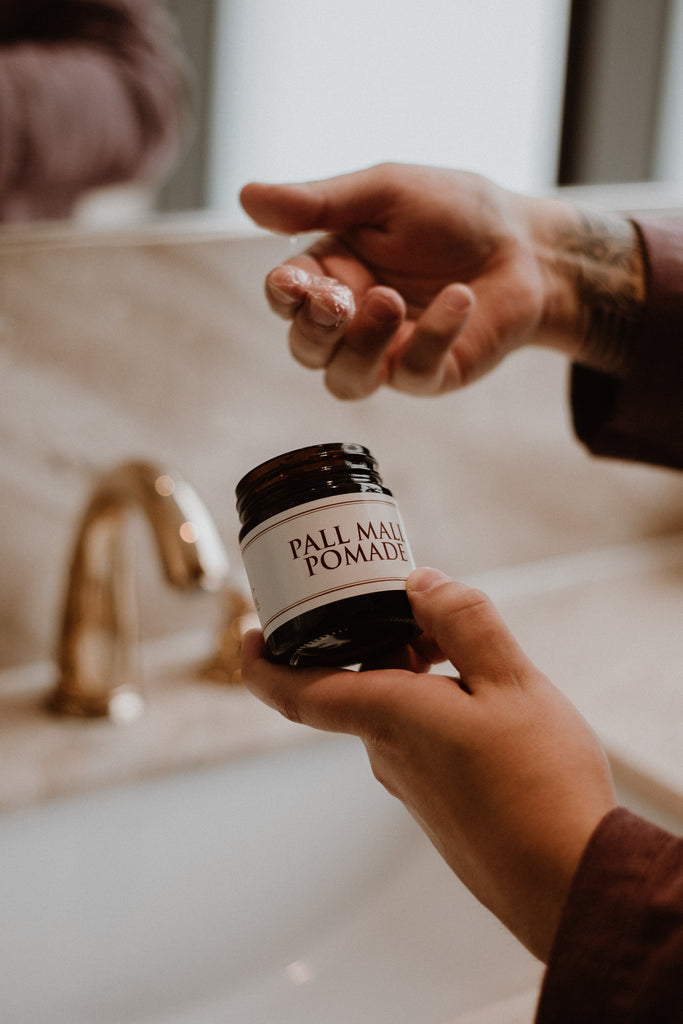 a man getting ready in the bathroom using our pall mall pomade