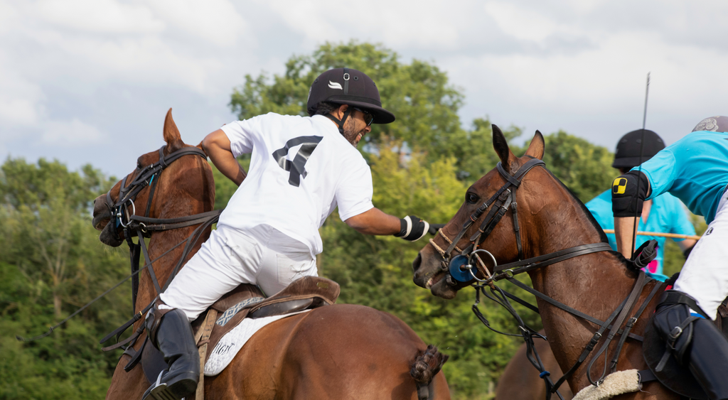 players on polo ponies hotting the ball