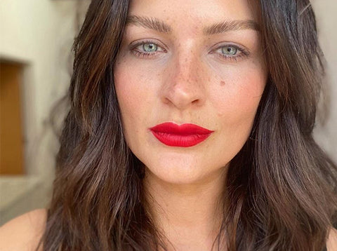 A woman with long brown hair and red lipstick - Josh Wood Hair Colour Expert