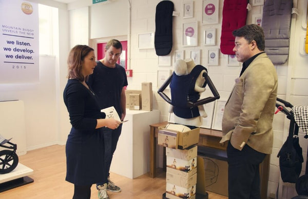 CEO Campbell Gower with marketing and design team members discussing Juno™ child carrier in-store point of sale material - Mountain Buggy