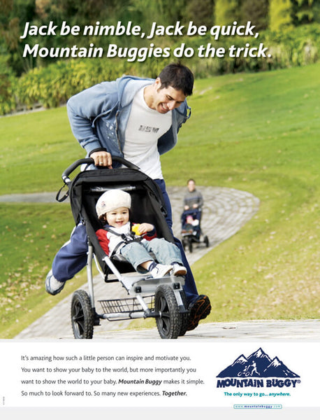 Man running at the park with toddler in our early model stroller design - mountain buggy