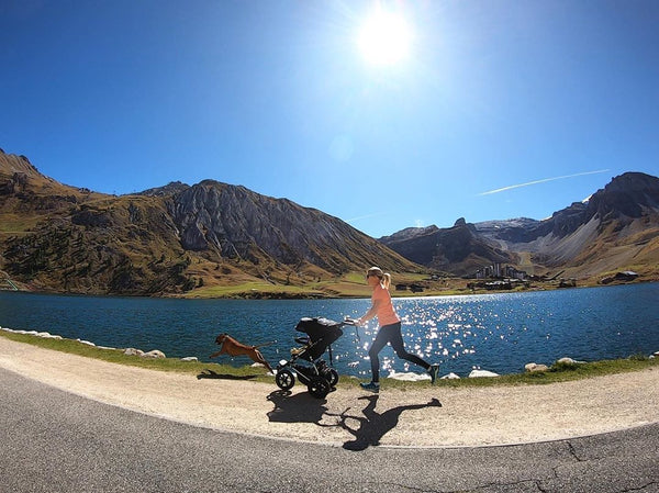 Squash Falconer jogging with her baby in Mountain Buggy terrain