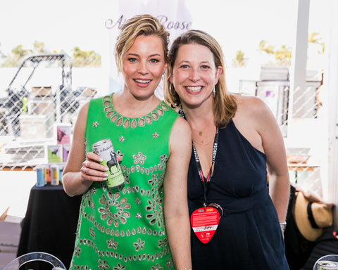Elizabeth Banks, co-owner and Chief Creative Officer of Archer Roose Wines and Marian Leitner-Waldman, co-founder and CEO of Archer Roose Wines featured in OK Magazine while at South Beach Wine and Food Festival