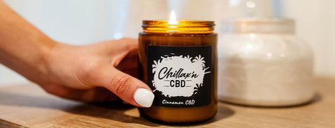 hand on lit chillax'n CBD candle 