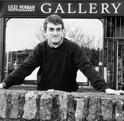 A black and white image of Giles standing outside his gallery on 45 Main Street in 1995