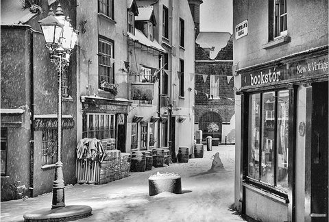 A black and white image of Kinsale's Greyhound pub and bookstór under snow.