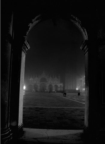 A black and white image of St. Mark's Square in Venice at night.