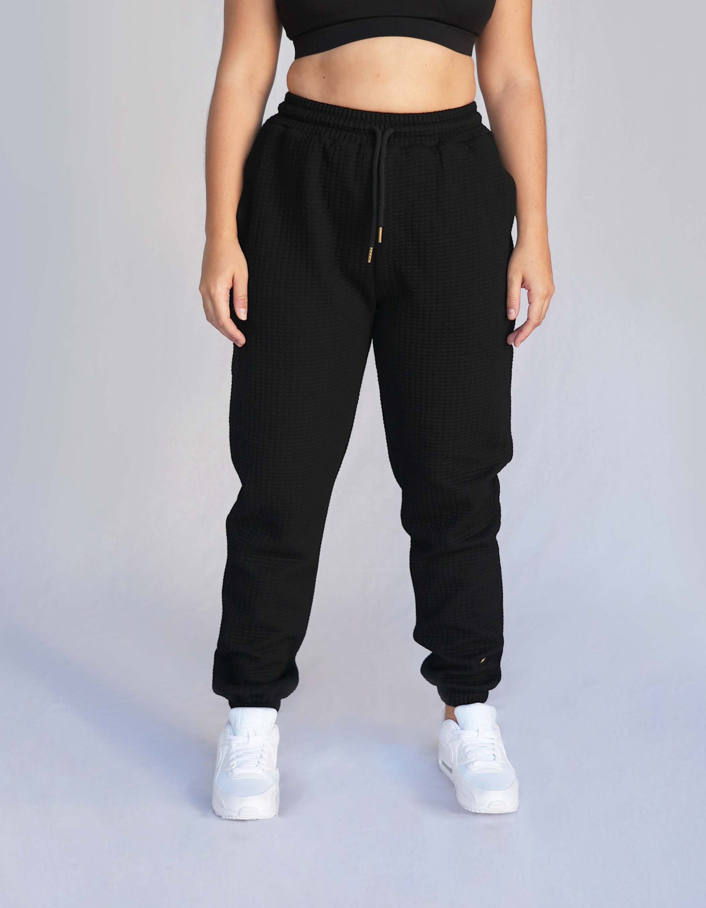 Crimson tavernorlando Phaedra Joggers in the color black. Waffle texture with pockets and drawstring to adjust the waistband.