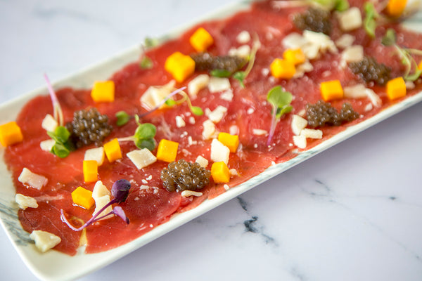 Carpaccio de terna con perlas de trufa negra