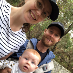 A mum, dad and baby on a walk outside