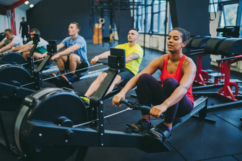 Rowing machines in action in the gym