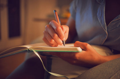 a woman journals before sleep