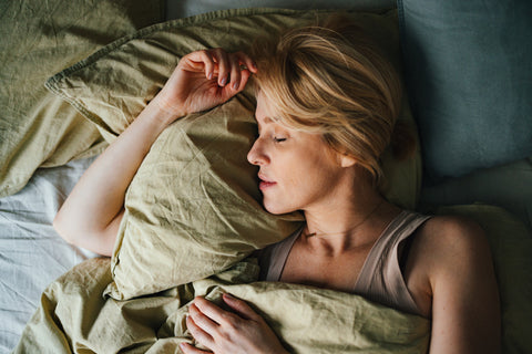 a woman sleeps peacefully in bed