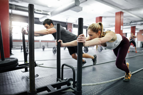 Group performing a sled push