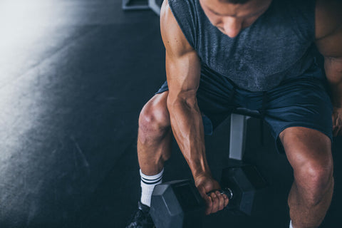 man sitting lifting weights