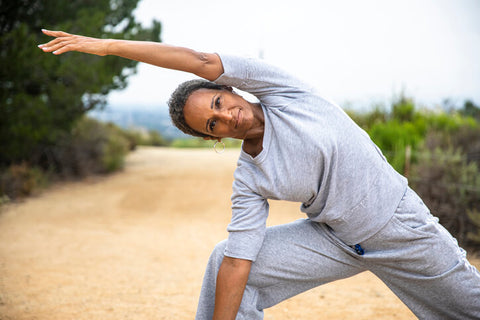 older woman doing yoga to ease menopause