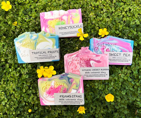 hand made soaps in grass with buttercups