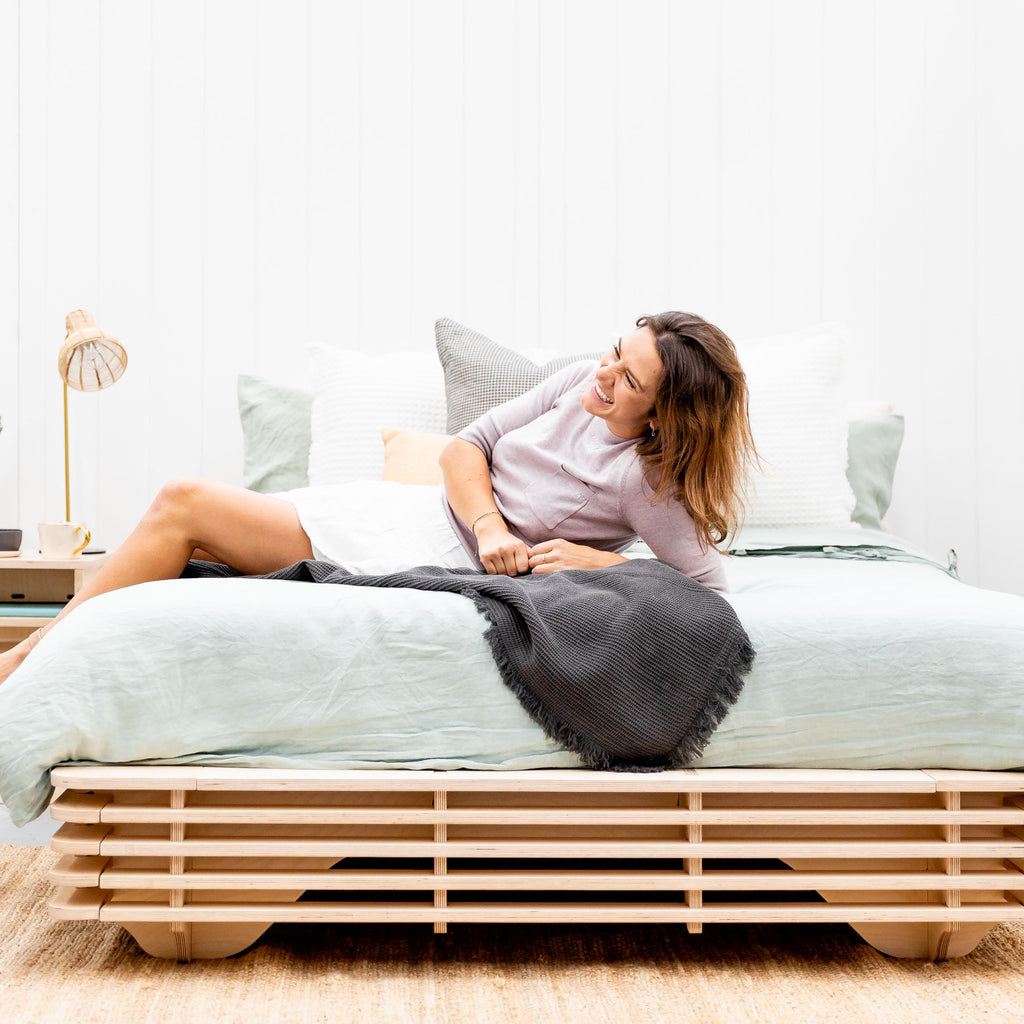 lady happy relaxing on new bed