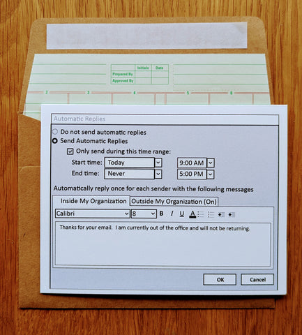 Picture of an accounting themed greeting card on top of a ledger paper lined envelope
